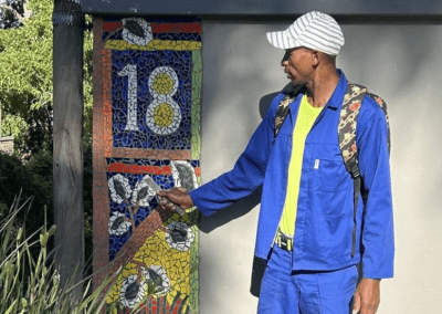 William poses with his first mosaic artwork